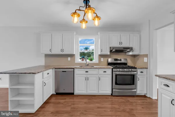 a kitchen with stainless steel appliances white cabinets and a sink