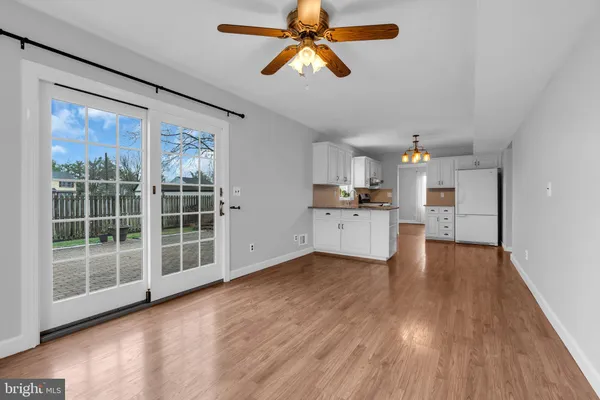 a view of a kitchen with wooden floor and a kitchen