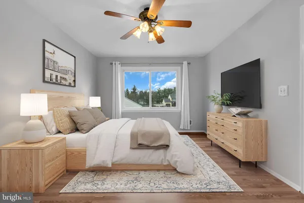 a bedroom with a bed and a flat screen television