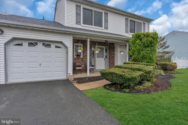 a view of a house with a small yard and a large window