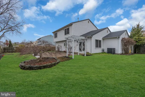 a front view of a house with a garden and plants