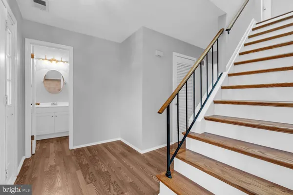 a view of entryway with wooden floor and stairs