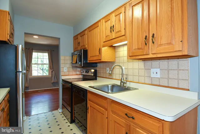 a kitchen with stainless steel appliances a refrigerator and cabinets