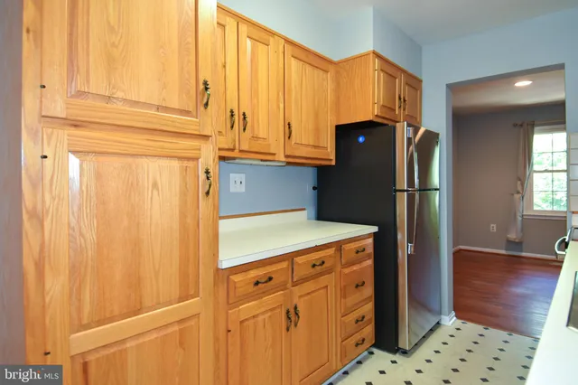 a kitchen with a sink and a refrigerator