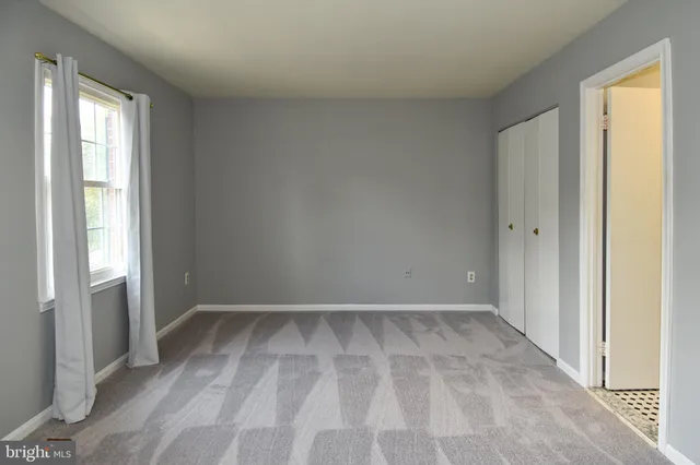 a view of a room with a wardrobe space and a sink