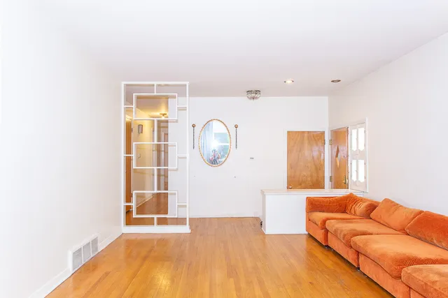 a living room with a bed furniture and a window