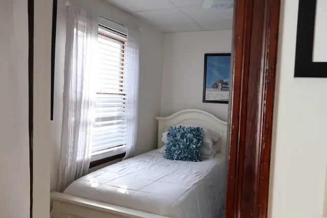 a living room with furniture a flat screen tv and kitchen view