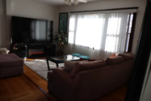 a kitchen with stainless steel appliances granite countertop a refrigerator a stove and a sink with wooden floor