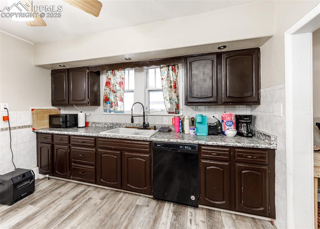 2010 East Routt Avenue Pueblo, CO 81004 - Photo 12 of 24 a kitchen with granite countertop a sink cabinets and window