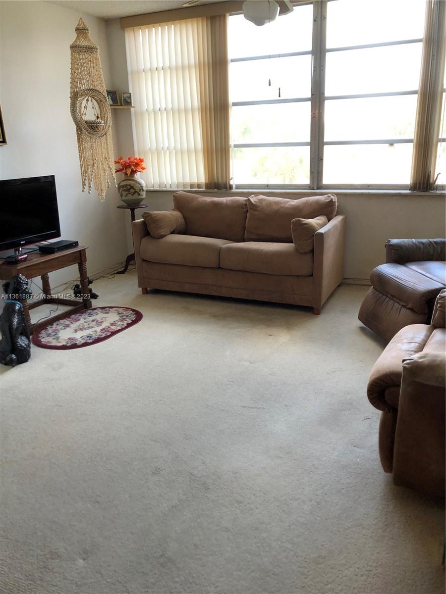 Royal Oaks Miami, FL 33179 - Photo 1 of 18 a living room with furniture and a window