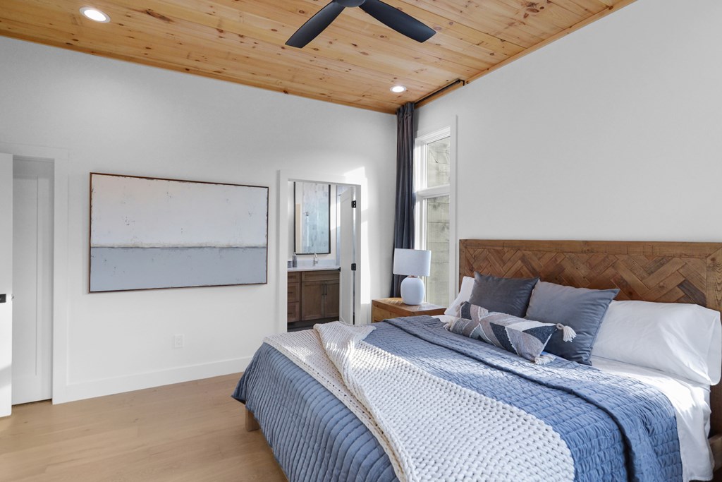 45 Eagle Watch Court Blue Ridge, GA 30513 - Photo 23 of 58 a bedroom with a large bed and a chandelier