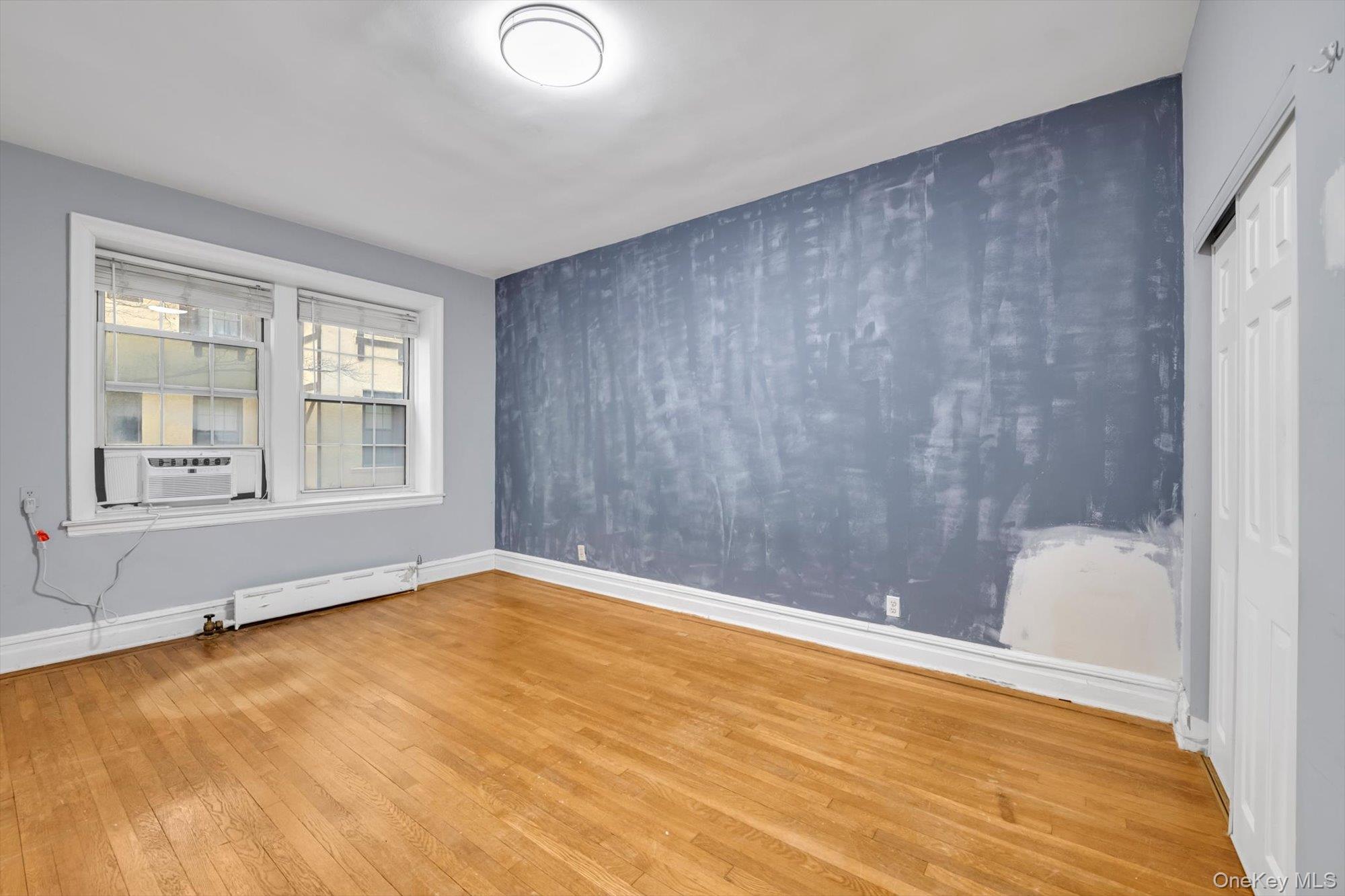 4 Maple Drive, Unit 1J Great Neck, NY 11021 - Photo 13 of 15 a view of an empty room with a window