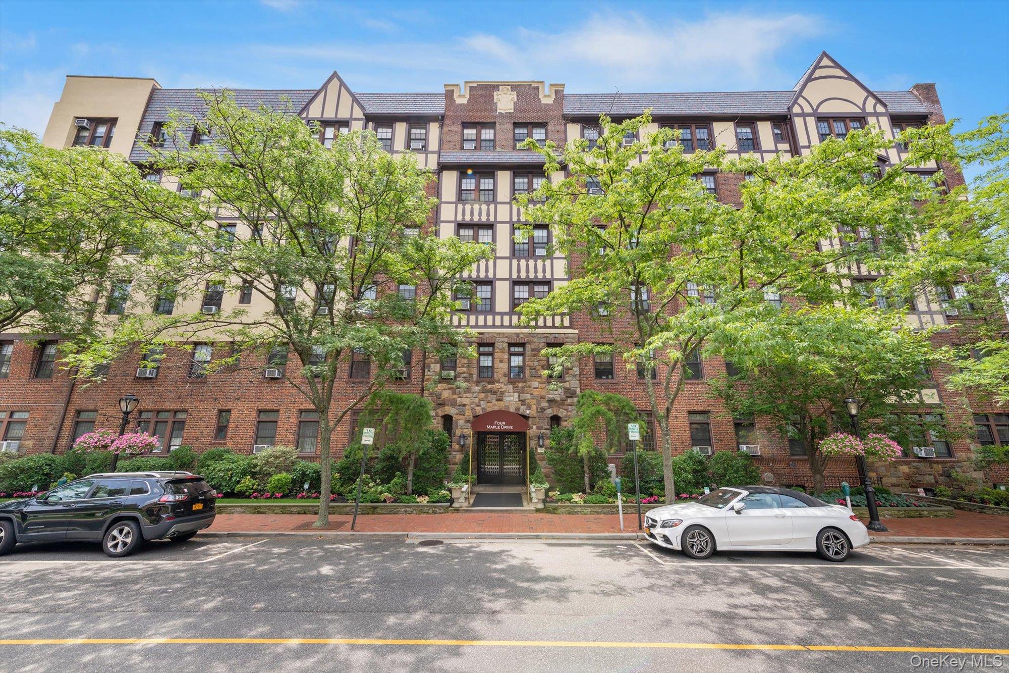 4 Maple Drive, Unit 1J Great Neck, NY 11021 - Photo 2 of 15 a car parked in front of a building