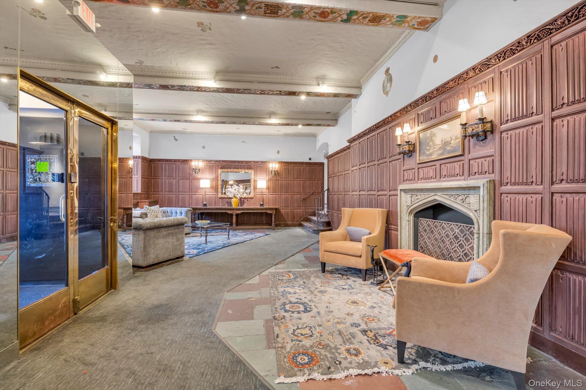 4 Maple Drive, Unit 1J Great Neck, NY 11021 - Photo 3 of 15 a living room with furniture and a fireplace
