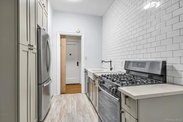 a kitchen that has a stove and a wooden floor