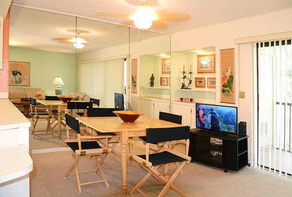 a view of a dining room with furniture and chandelier