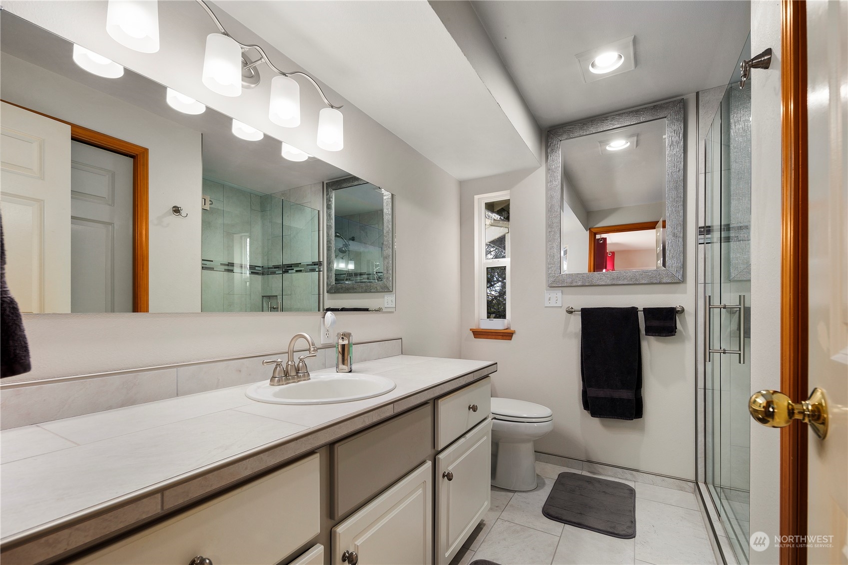 17005 51st Avenue Southeast Bothell, WA 98012 - Photo 18 of 40 a bathroom with a sink a toilet and mirror