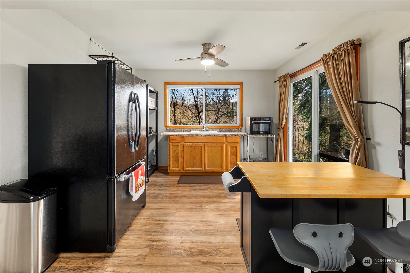 17005 51st Avenue Southeast Bothell, WA 98012 - Photo 26 of 40 a kitchen with stainless steel appliances wooden floor and a refrigerator