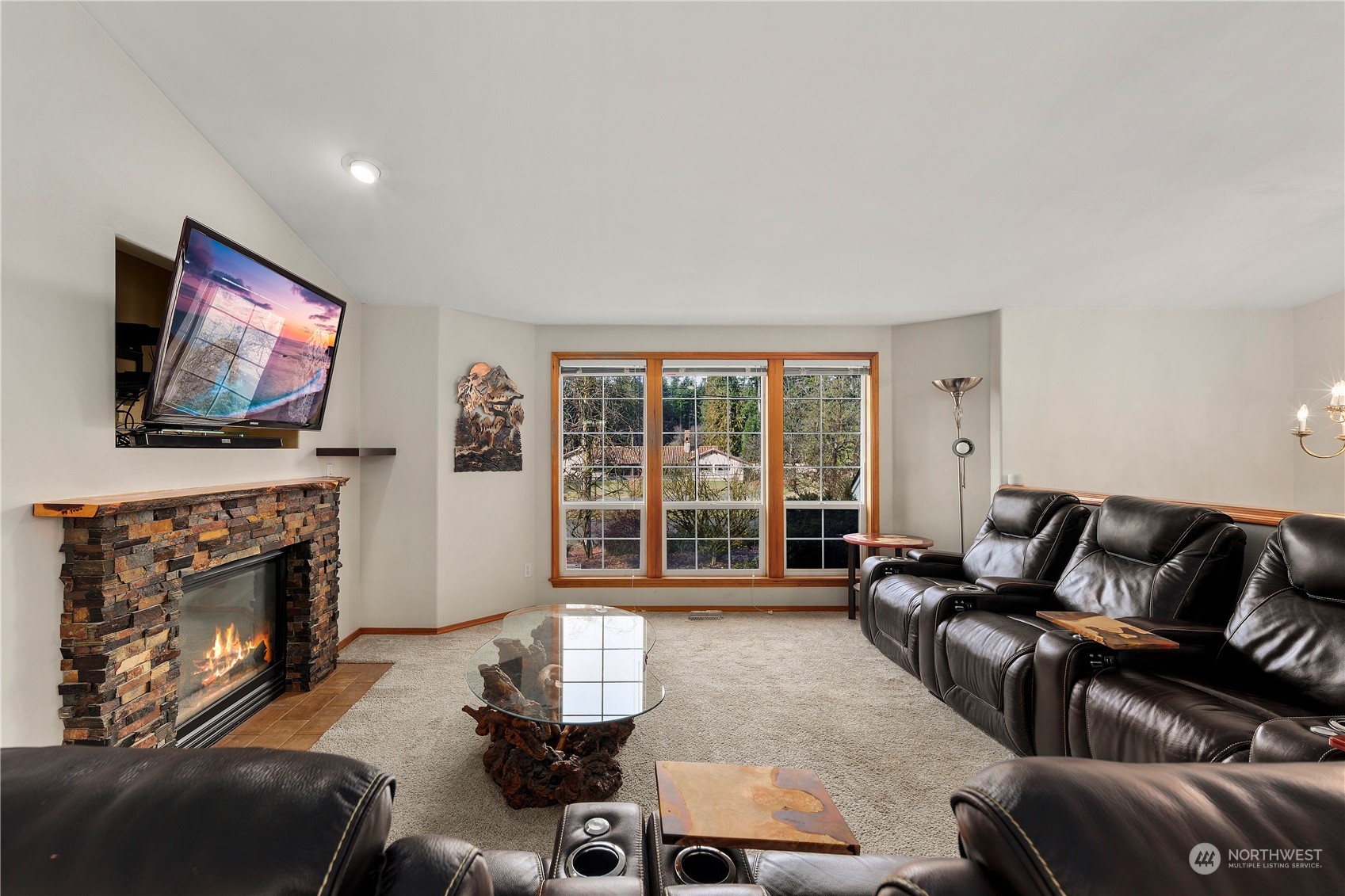17005 51st Avenue Southeast Bothell, WA 98012 - Photo 5 of 40 a living room with furniture a flat screen tv and a fireplace