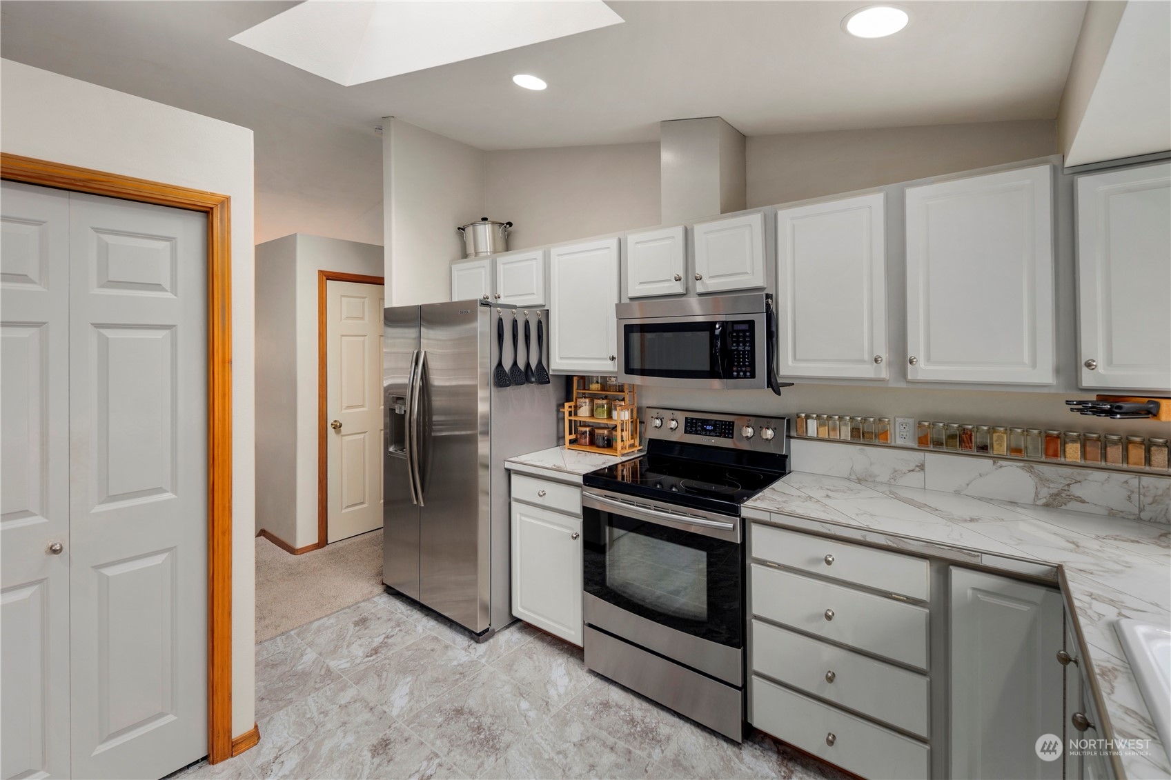 17005 51st Avenue Southeast Bothell, WA 98012 - Photo 6 of 40 a kitchen with stainless steel appliances a stove microwave and refrigerator