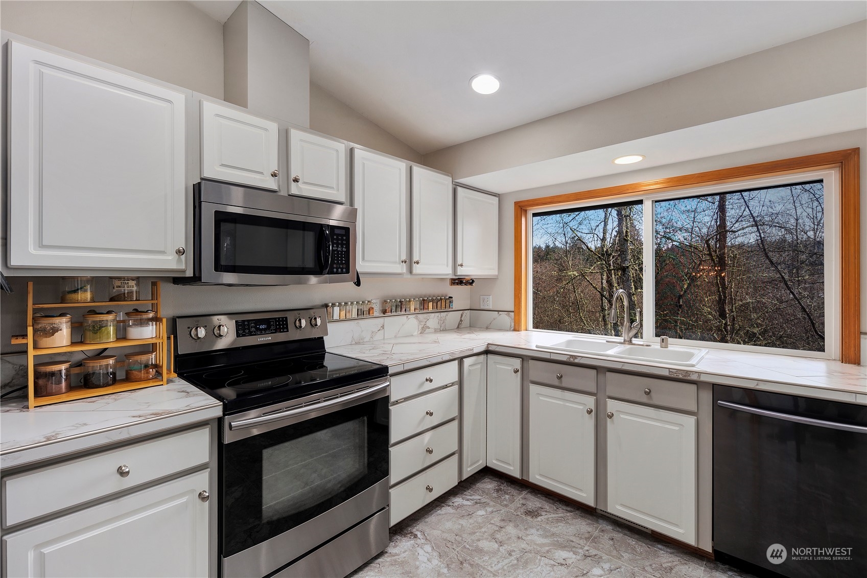 17005 51st Avenue Southeast Bothell, WA 98012 - Photo 7 of 40 a kitchen with a sink stove and microwave