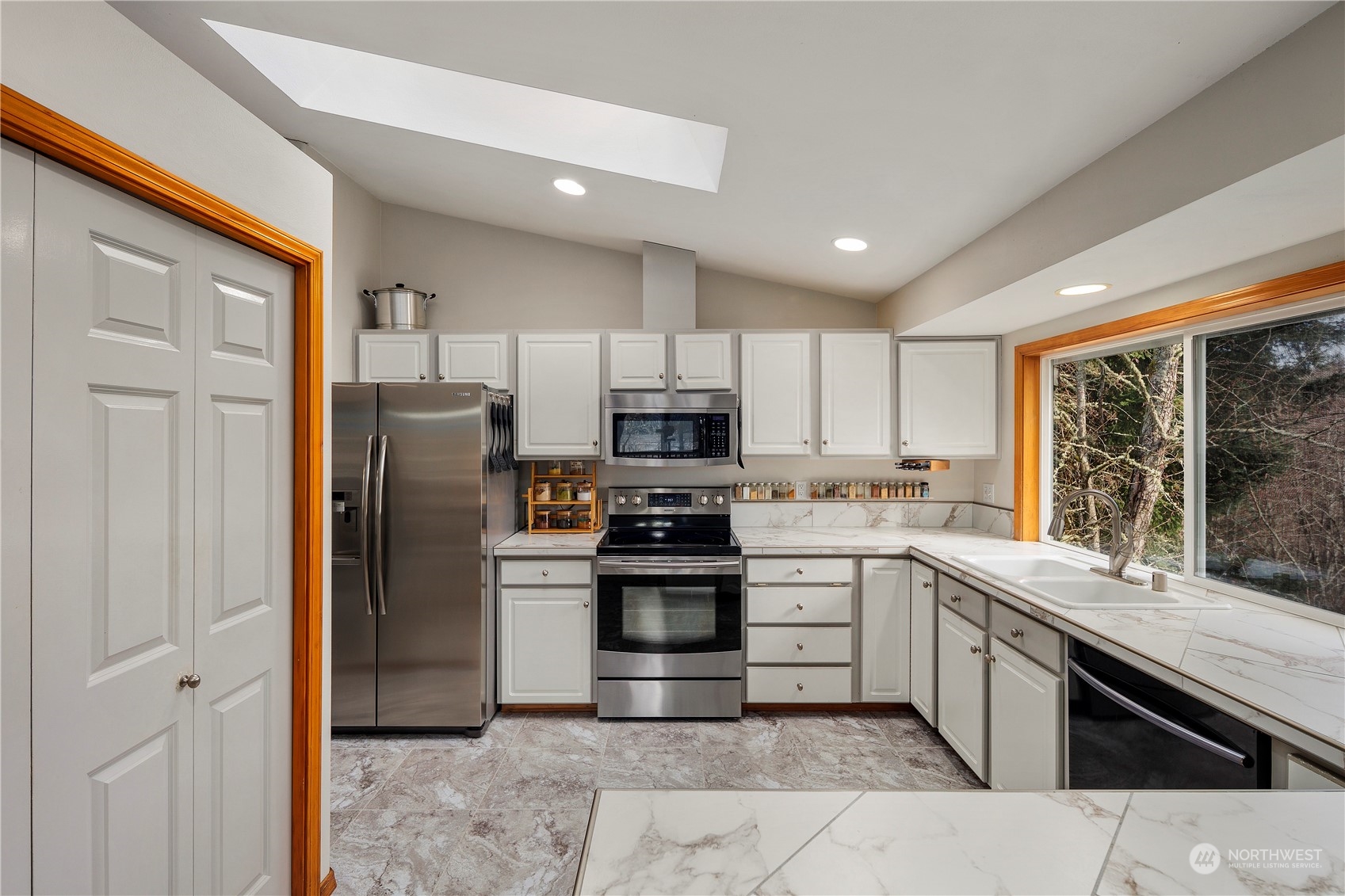 17005 51st Avenue Southeast Bothell, WA 98012 - Photo 8 of 40 a kitchen with stainless steel appliances granite countertop a refrigerator and a stove top oven