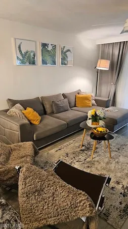 a living room with a couch and a rug