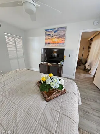a bedroom with a bed mirror and flat screen tv