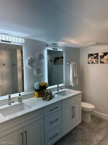 a bathroom with a double vanity sink and a mirror