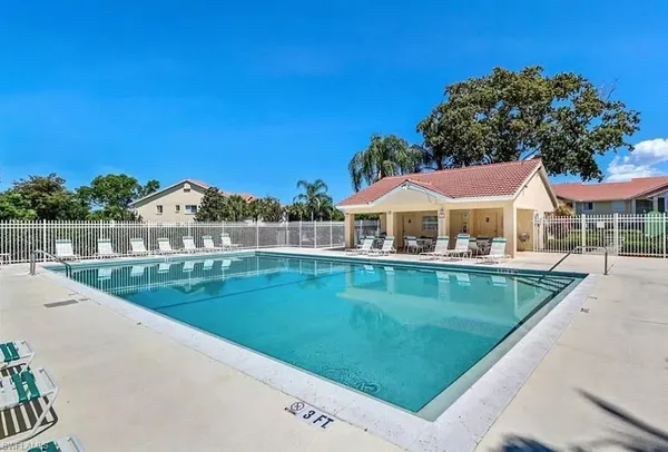a view of house with outdoor space and swimming pool