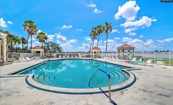 a view of a swimming pool with outdoor seating