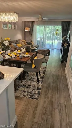 a living room with furniture and a floor to ceiling window