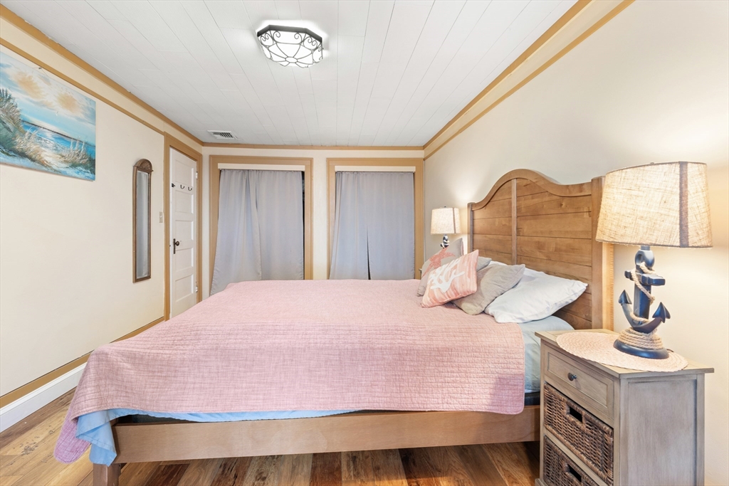 278 A Delano Road Marion, MA 02738 - Photo 17 of 32 a bedroom with a bed and dresser with mirror