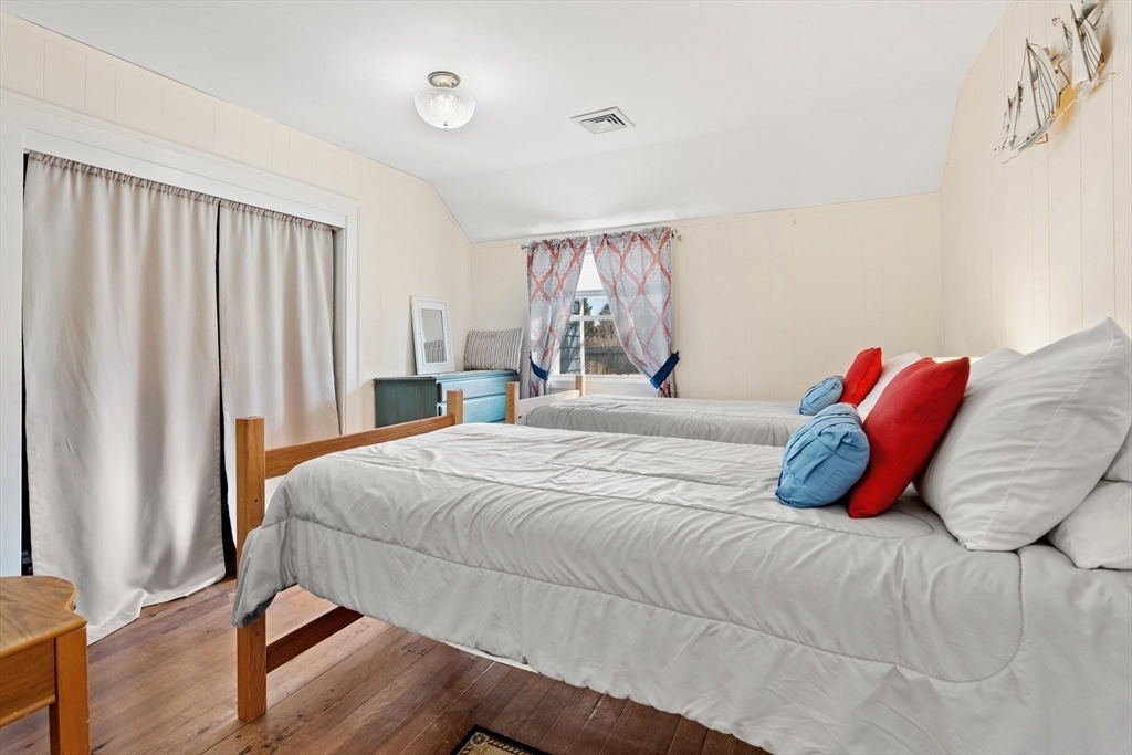 278 A Delano Road Marion, MA 02738 - Photo 21 of 32 a bedroom with a bed and wooden floor