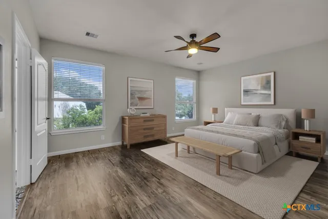 a bedroom with a large bed and a large window