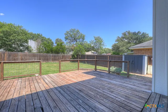 a kitchen with stainless steel appliances granite countertop wooden cabinets a refrigerator a sink a stove a microwave and island