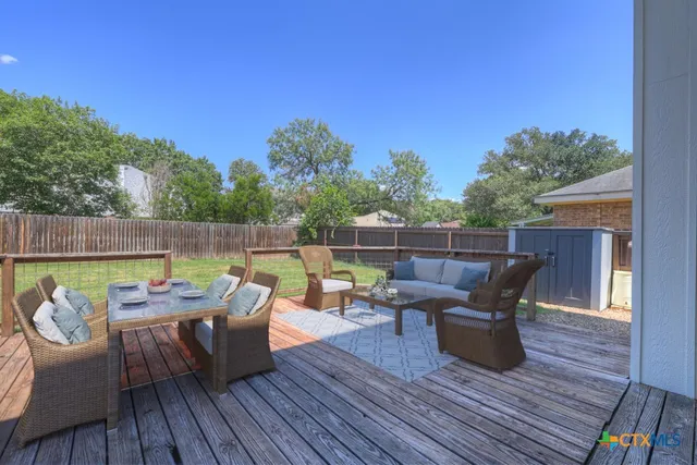 a kitchen with stainless steel appliances granite countertop a sink dishwasher stove and cabinets with wooden floor
