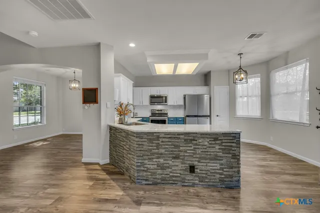 a living room with fireplace furniture and a wooden floor