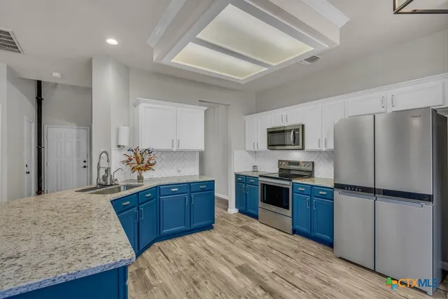 a kitchen with refrigerator and window