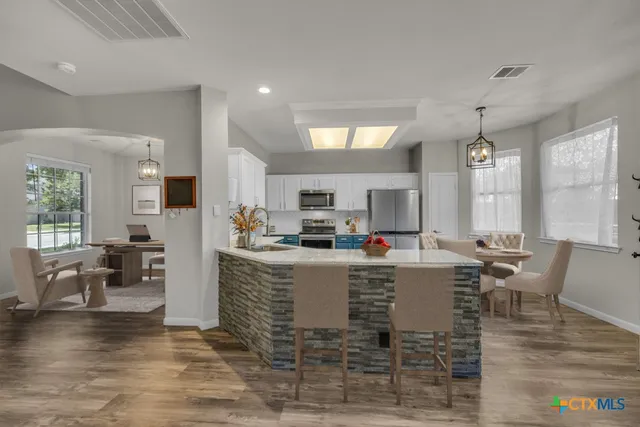 a living room with fireplace furniture and a wooden floor