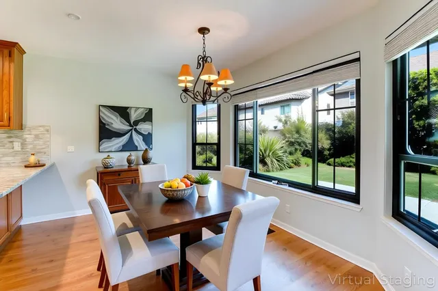 a view of a dining room with furniture wooden floor and chandelier