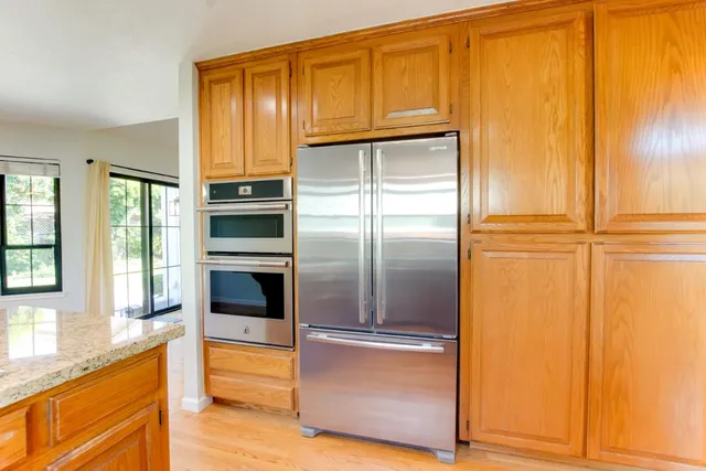 a kitchen with a refrigerator and cabinets