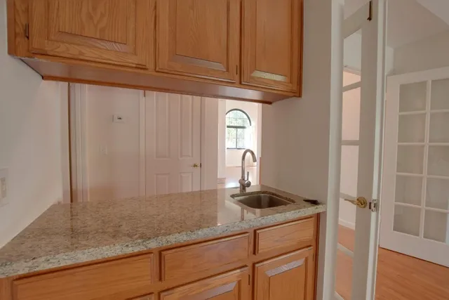 a kitchen with cabinets and a window
