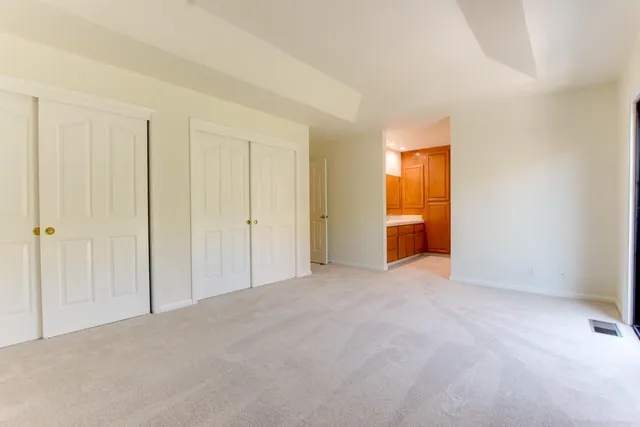 a view of an empty room and a window