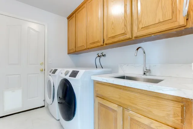 a kitchen with a sink and a washer dryer