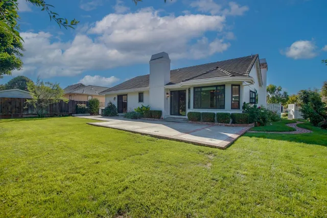 a view of house with swimming pool yard and outdoor seating