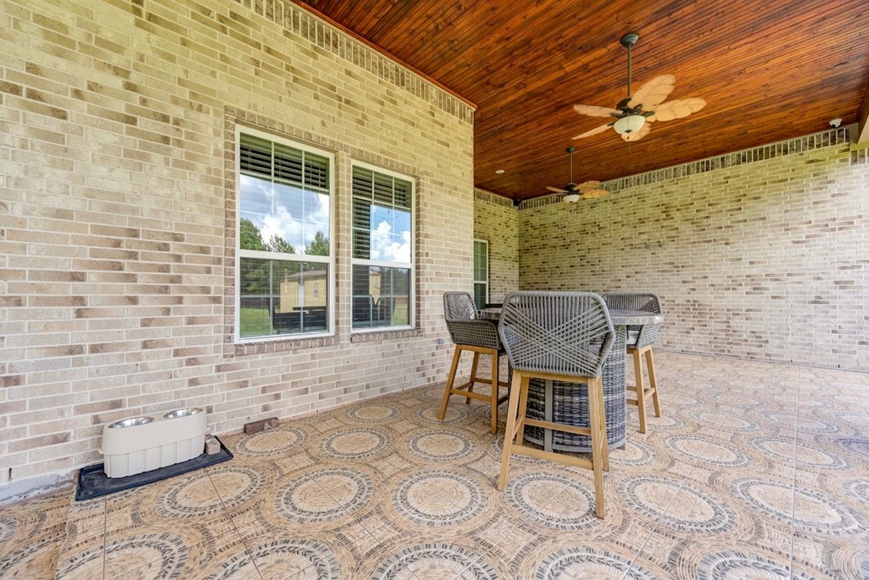 21038 Angus Drive Cleveland, TX 77328 - Photo 44 of 49 a patio with table and chairs and potted plants