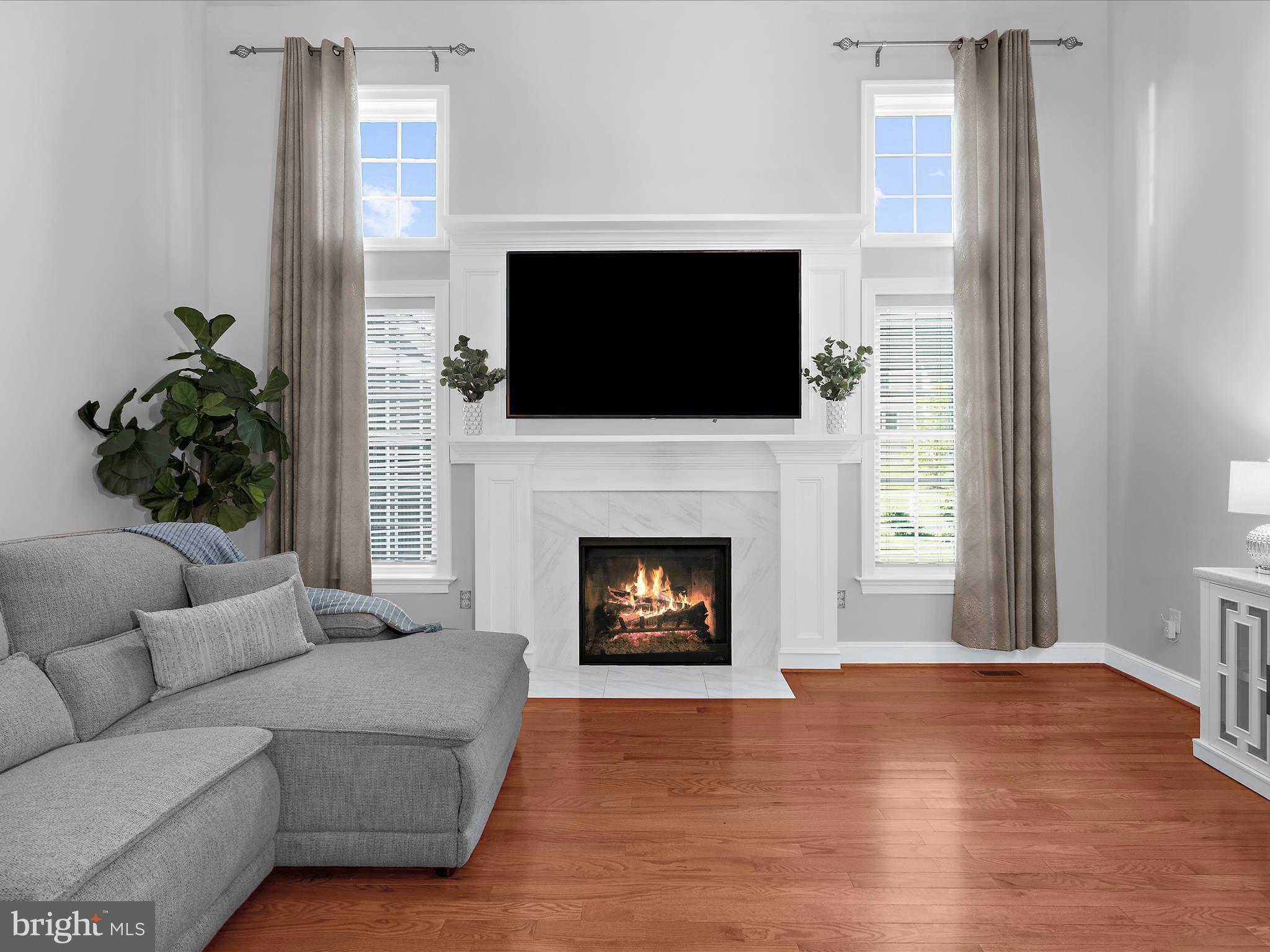 13801 Racetrack Field Court Bowie, MD 20720 - Photo 19 of 66 a living room with furniture a flat screen tv and a fireplace