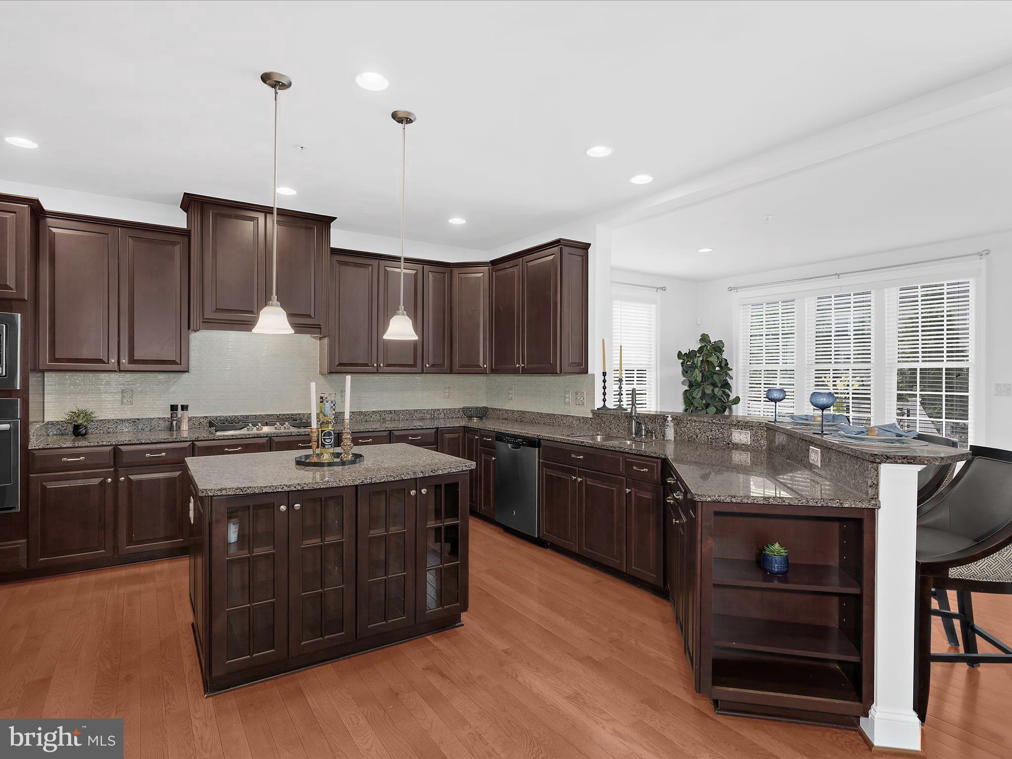 13801 Racetrack Field Court Bowie, MD 20720 - Photo 22 of 66 a kitchen with stainless steel appliances granite countertop wooden cabinets a stove a sink and a refrigerator