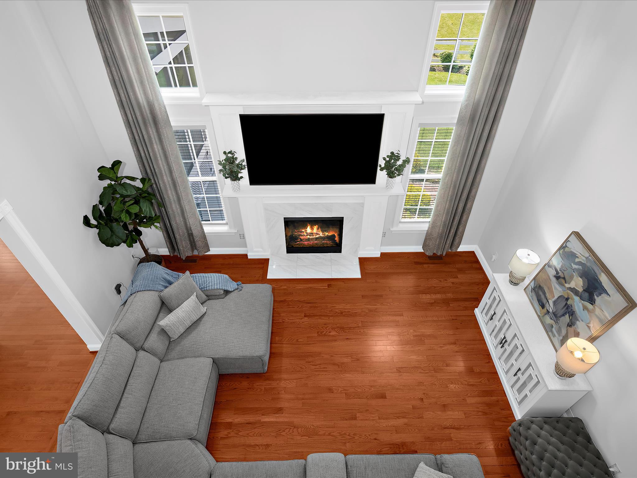 13801 Racetrack Field Court Bowie, MD 20720 - Photo 29 of 66 a living room with furniture a flat screen tv and a fireplace